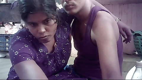 Indian brunette in a red dress and a black shirt is sucking