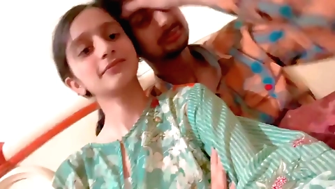Indian brunette girl kisses and rubs her boyfriend