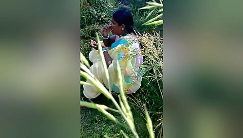 Indian woman is outdoors with her body in a bikini and a dress