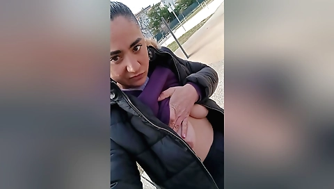 Amateur brunette in the park masturbating outdoors